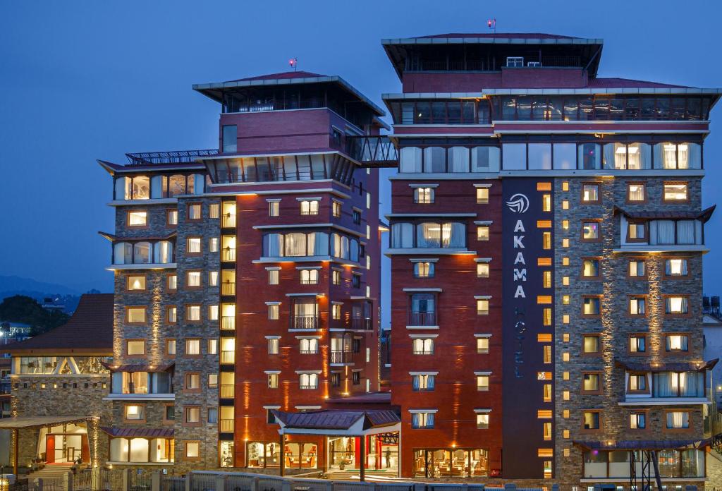 a large apartment building with lights on at Akama Hotel Ltd in Kathmandu