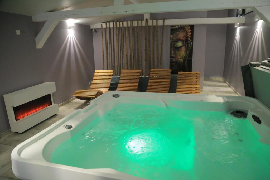 a bath tub in a room with a fireplace at H49 Apartman - Adults only in Sovata