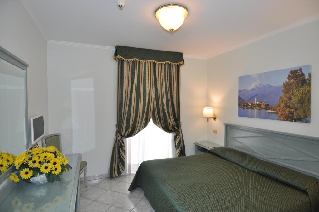 Posteľ alebo postele v izbe v ubytovaní Hotel Moderno - Cavour 30tre