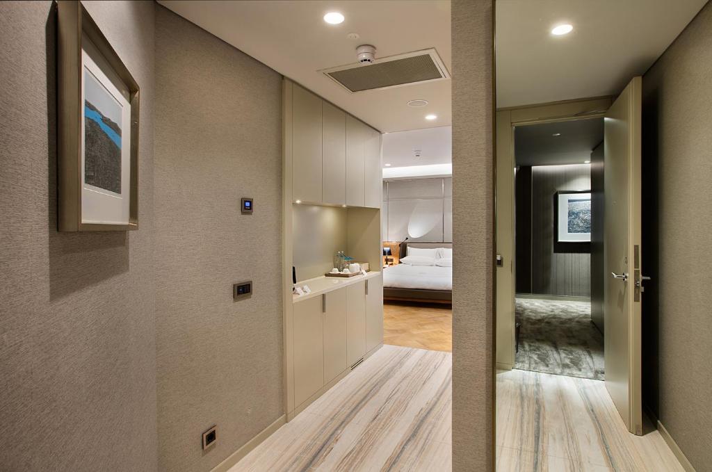 a hallway with a room with a bed and a hallway with a hallway at Fer Hotel in Istanbul