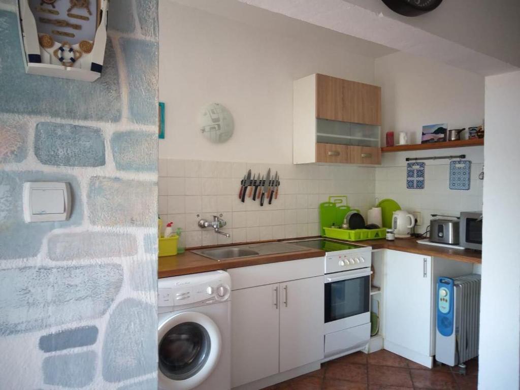 a kitchen with a washer and a sink and a stove at Marina House in Perast