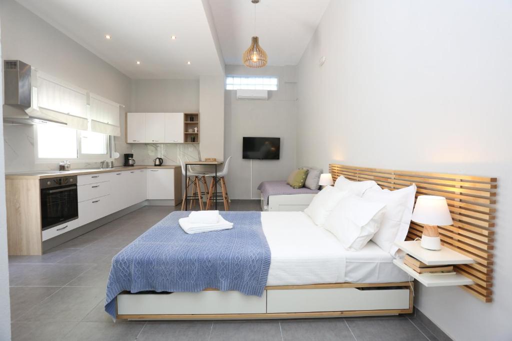 ein Schlafzimmer mit einem großen Bett und eine Küche in der Unterkunft Polychrono Suite 2 in Polychrono