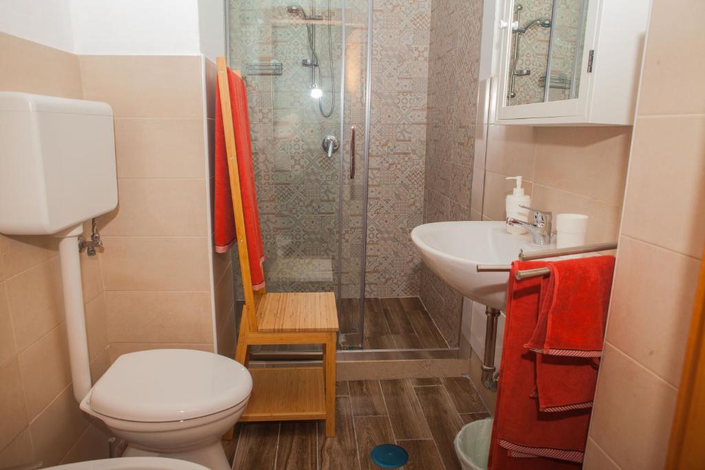 a bathroom with a shower and a toilet and a sink at La Bellavista Mola di Bari in Mola di Bari