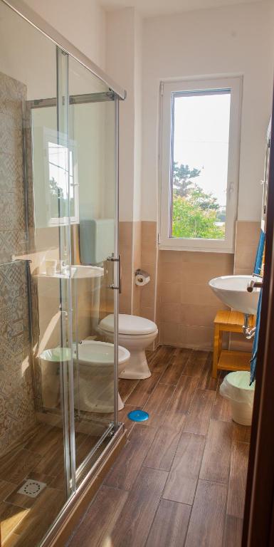 a bathroom with a shower and a toilet and a sink at La Bellavista Mola di Bari in Mola di Bari