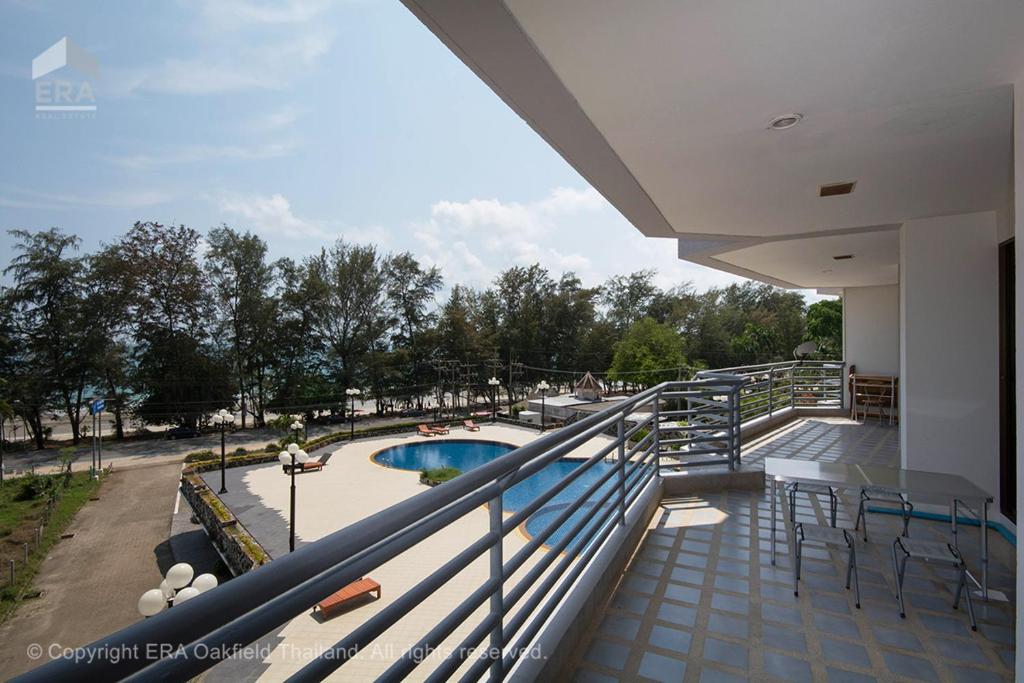 a balcony with a view of a swimming pool at Rayong by Milanee in Ban Phe