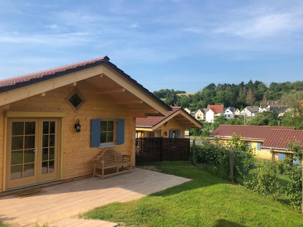 a small house with a patio in a yard at Carolinger Hüttendorf in Weyer