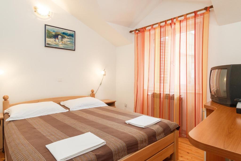 Postel nebo postele na pokoji v ubytování Apartments & Rooms Konoba Tomić
