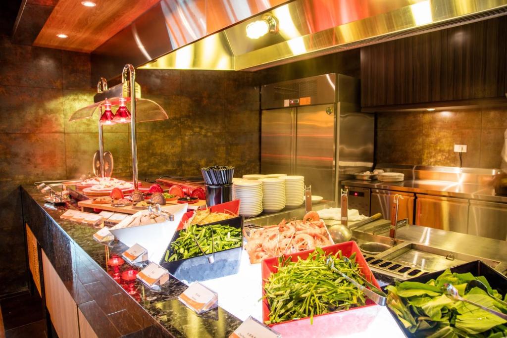a kitchen with a bunch of food on a counter at Fullon Hotel Taoyuan Airport Access MRT A8 in Guishan