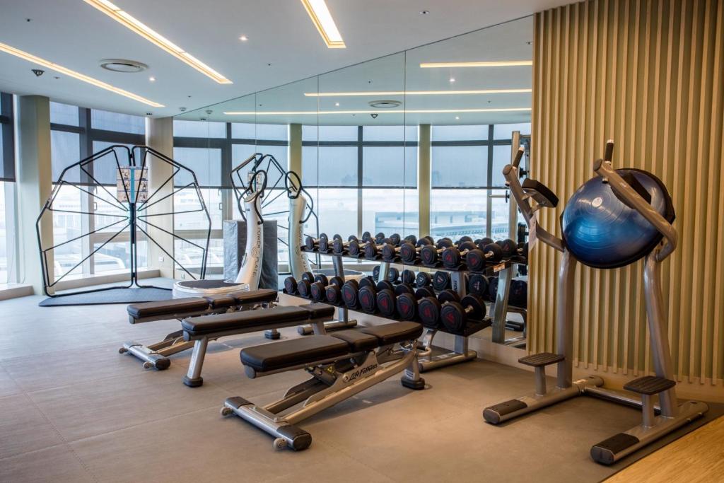 a gym with rows of exercise equipment in a building at Fullon Hotel Taoyuan Airport Access MRT A8 in Guishan