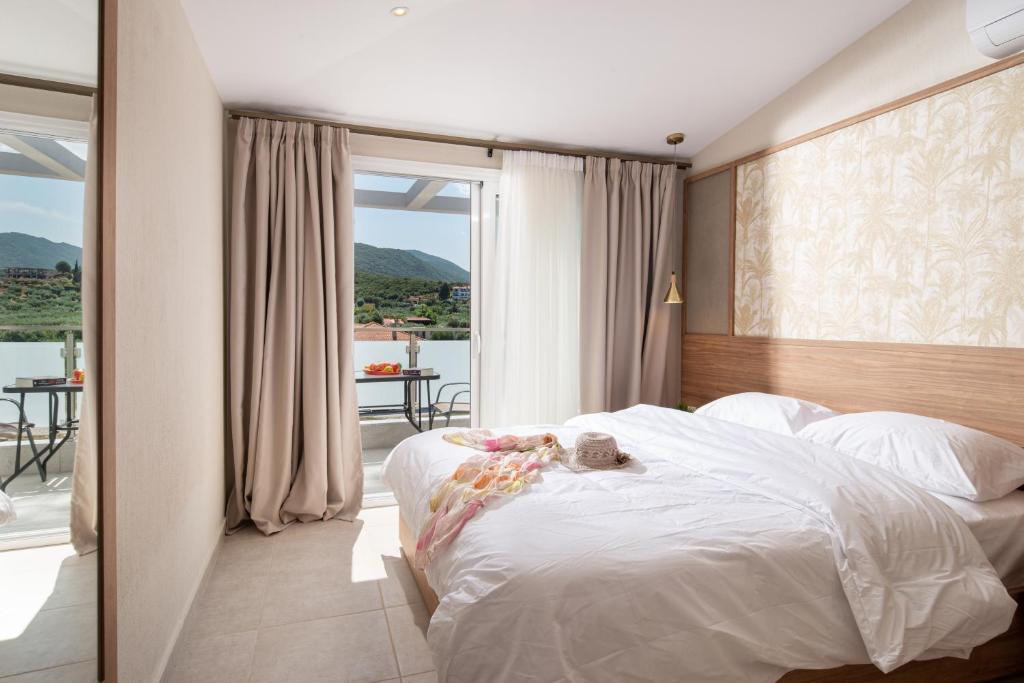 a bedroom with a bed with a teddy bear on it at Astra Sarti Luxury Suites in Sarti