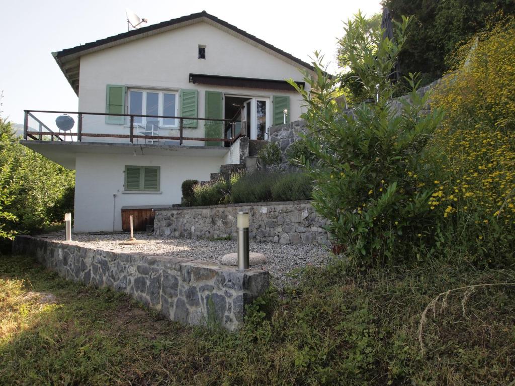a house with a stone retaining wall in front of it at Gais Alpins in Montreux