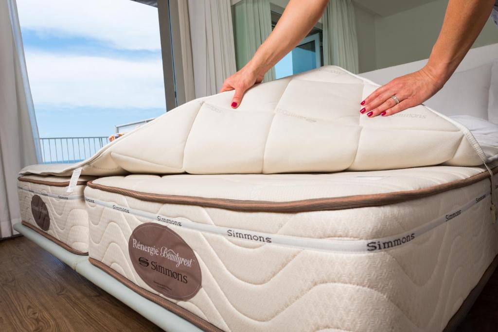 a person standing on a mattress in a room at Hotel Miramare - Adults Only in Trieste