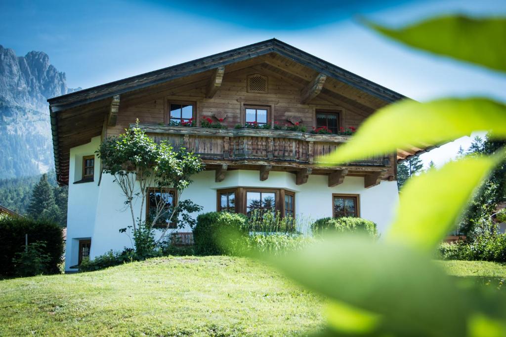 a house with a balcony on top of it at Chalet Glücklich sein... in Ellmau