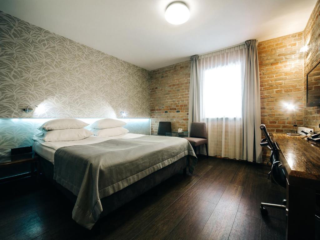 Posteľ alebo postele v izbe v ubytovaní Q Hotel Grand Cru Gdańsk