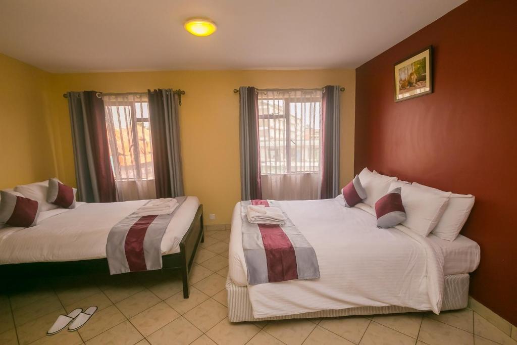 Postel nebo postele na pokoji v ubytování Plus254 Hotel