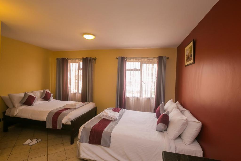 Postel nebo postele na pokoji v ubytování Plus254 Hotel