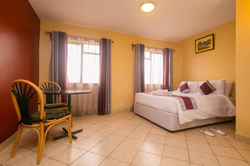 Postel nebo postele na pokoji v ubytování Plus254 Hotel