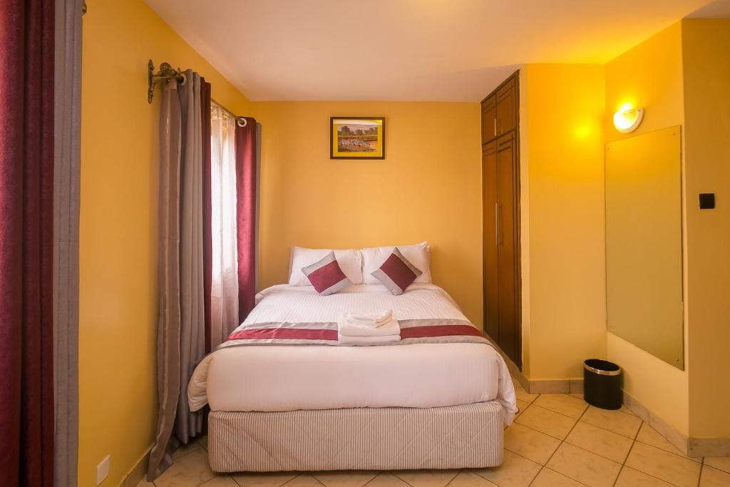 Postel nebo postele na pokoji v ubytování Plus254 Hotel