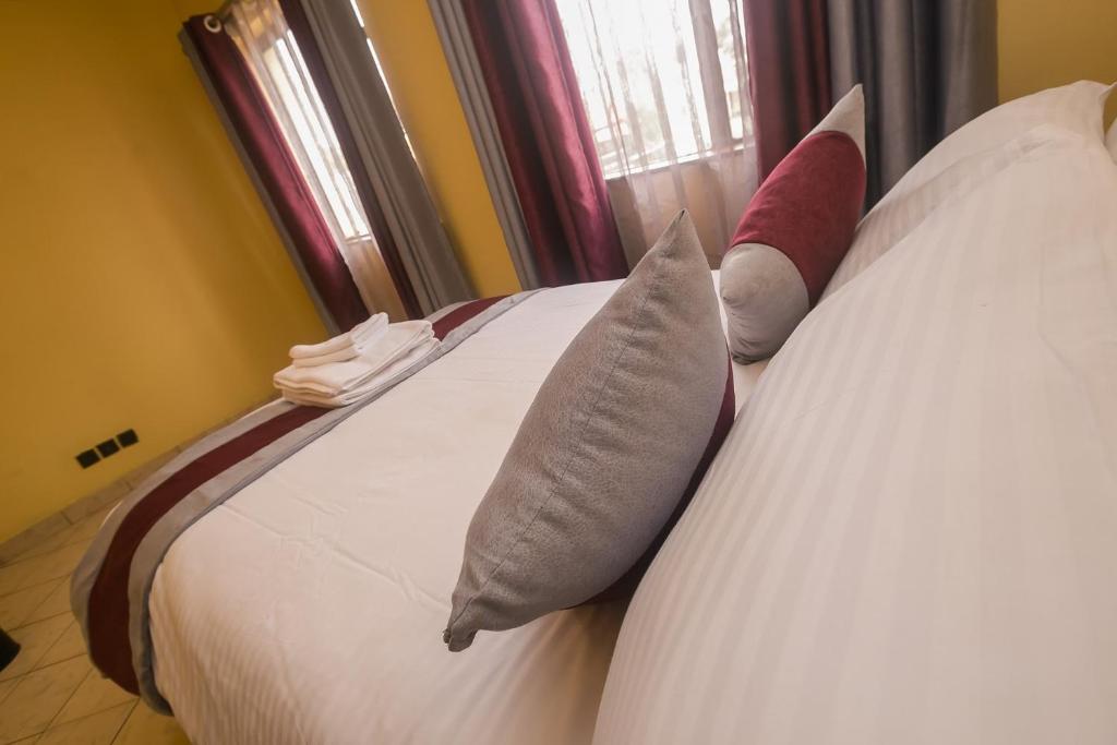 Postel nebo postele na pokoji v ubytování Plus254 Hotel