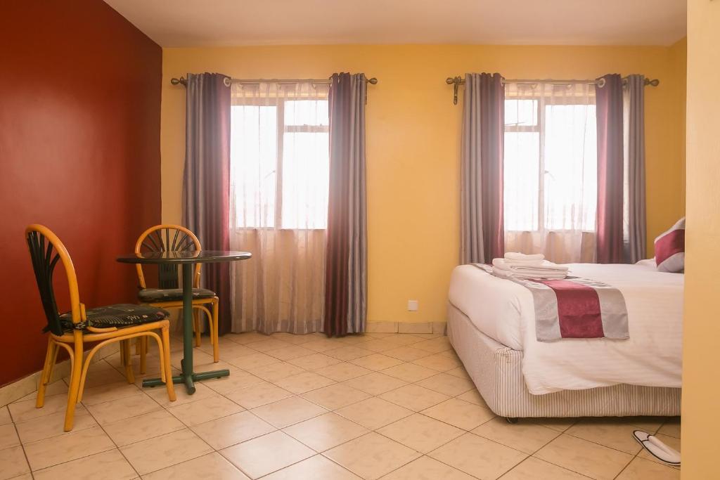 Postel nebo postele na pokoji v ubytování Plus254 Hotel