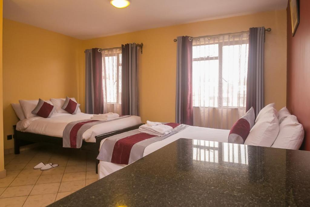 Postel nebo postele na pokoji v ubytování Plus254 Hotel