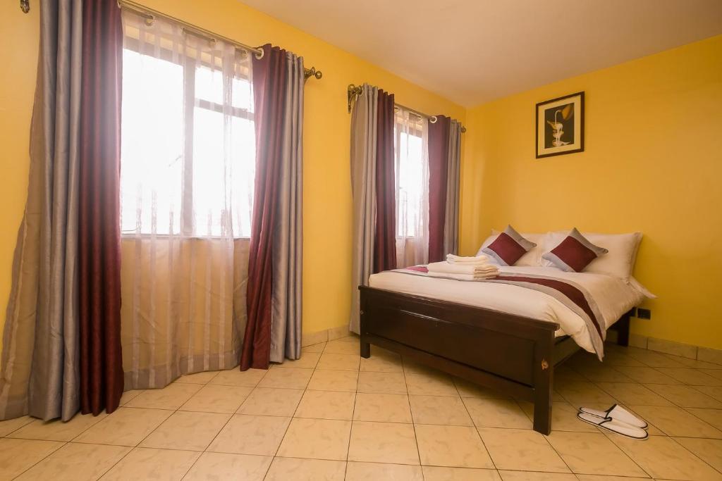 Postel nebo postele na pokoji v ubytování Plus254 Hotel