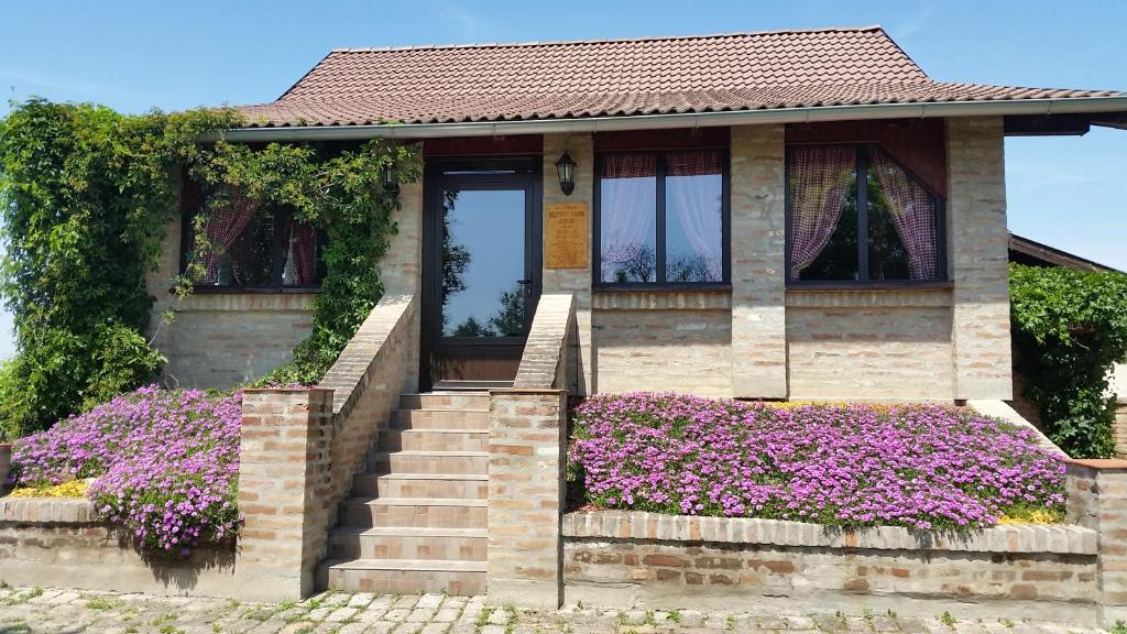 a house with purple flowers in front of it at Izletište Opatovac in Opatovac
