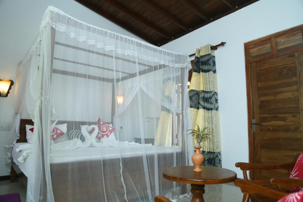 Postel nebo postele na pokoji v ubytování Villa Koggala