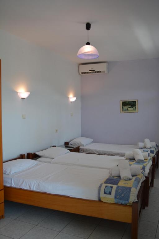 Postel nebo postele na pokoji v ubytování GLIKERIA ROOMS