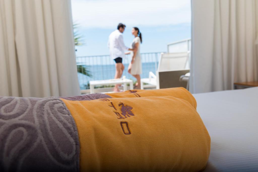 a man and a woman standing in a hotel room at Hotel Miramare - Adults Only in Trieste