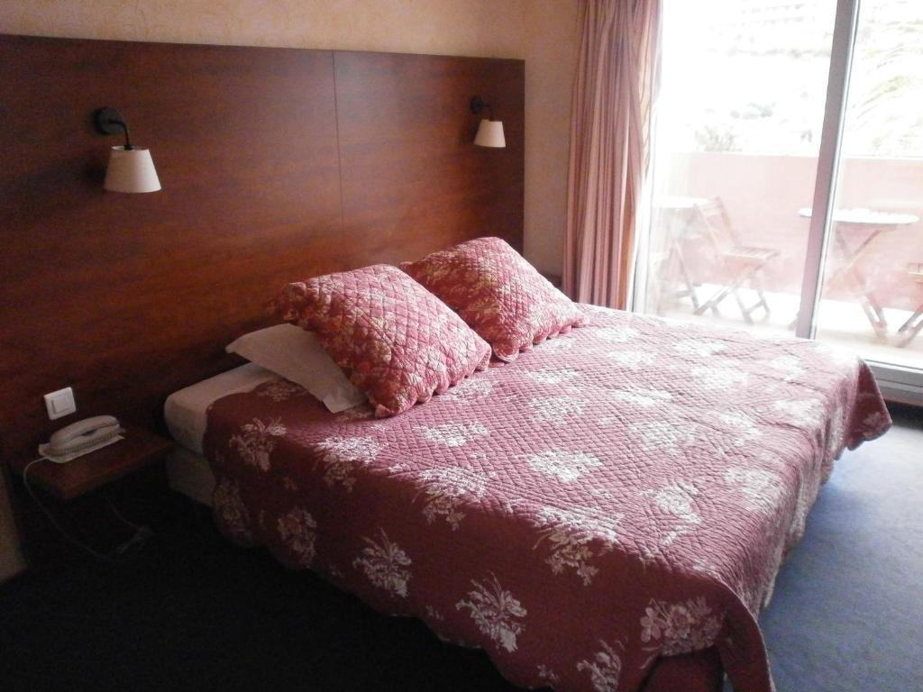 Postel nebo postele na pokoji v ubytování Hôtel Maya