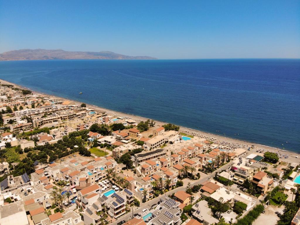 an aerial view of a beach with houses and the ocean at Athina Suites Luxury Suites Near The Sea Platanias in Platanias