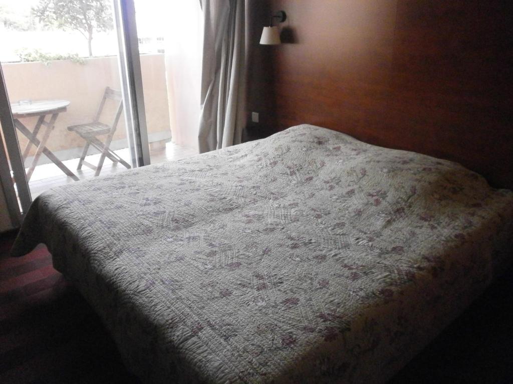 Postel nebo postele na pokoji v ubytování Hôtel Maya
