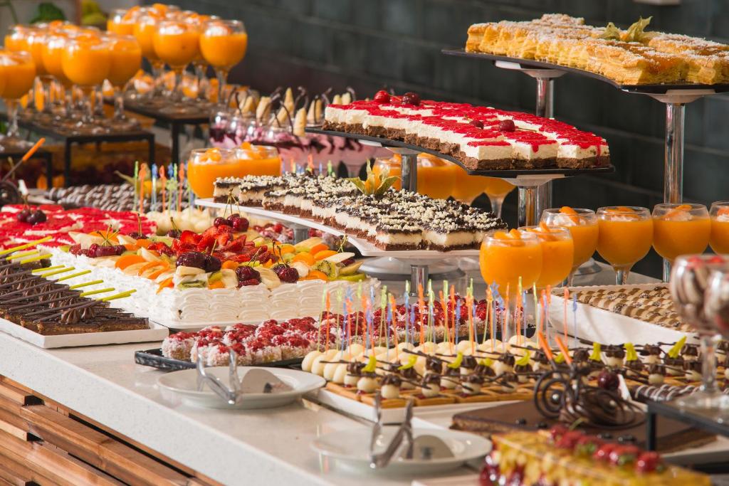 a buffet with many different types of cakes and desserts at Sunrise Blue Magic Resort - All Inclusive in Obzor