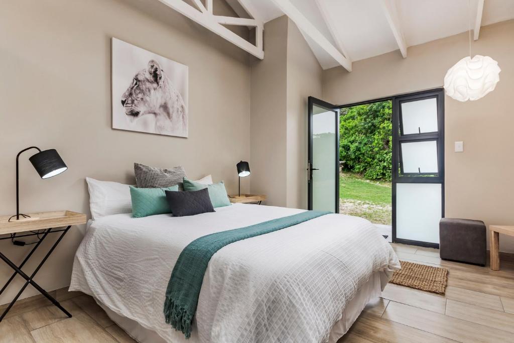 a bedroom with a bed and a desk and a window at 15 Port Elizabeth Country Getaway Deer Park estate15 in Port Elizabeth