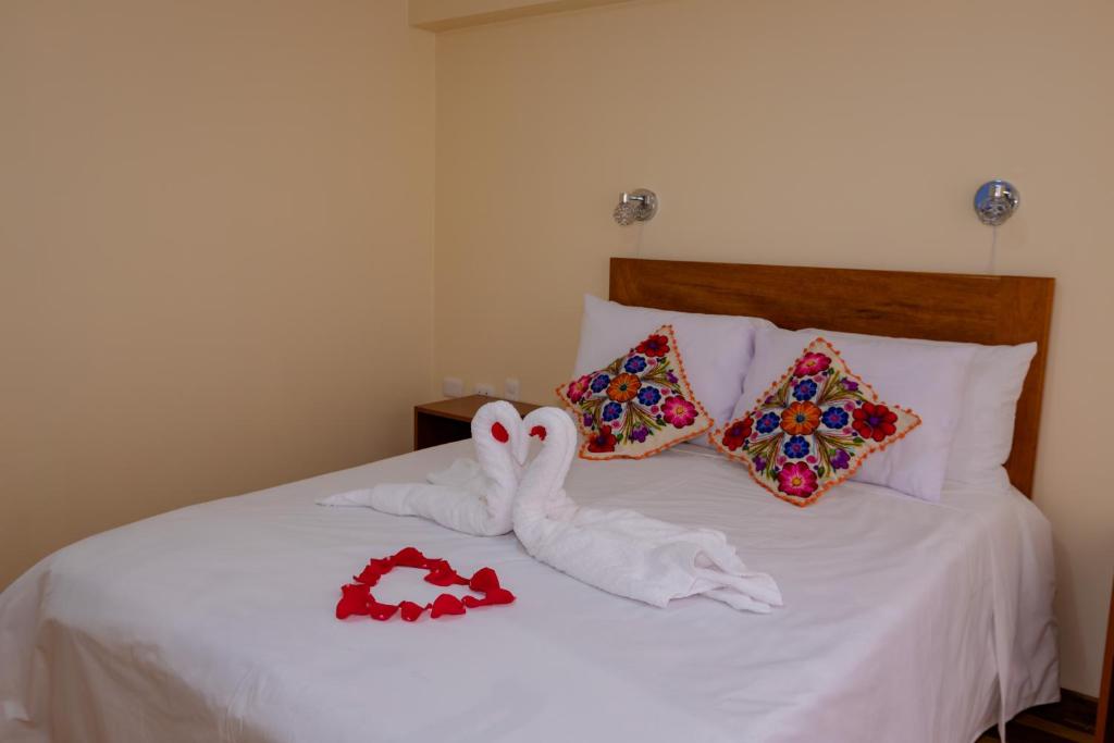 Łóżko lub łóżka w pokoju w obiekcie Hawka Inka Hostal - Cusco
