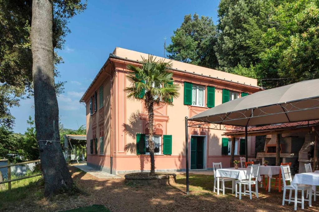 a house with a palm tree in front of it at La BRIGNA B&B Il bosco sul mare in Genova