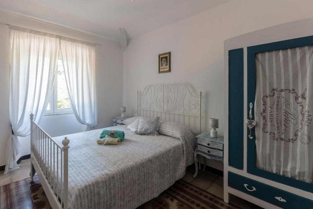 a bedroom with a bed with a teddy bear on it at La BRIGNA B&B Il bosco sul mare in Genoa