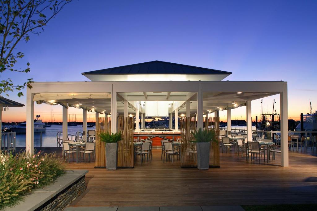 a gazebo with chairs and tables on a deck at Forty 1 North in Newport