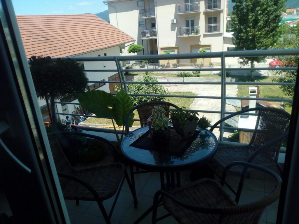a balcony with chairs and a table with plants on it at Агни in Vrnjačka Banja