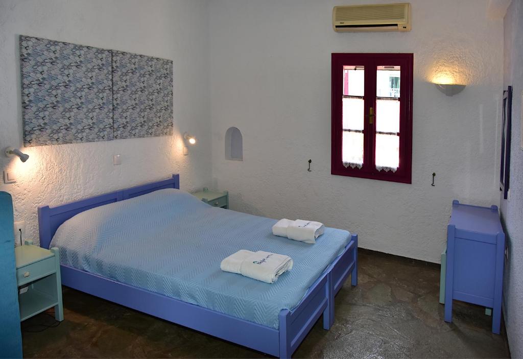 Postel nebo postele na pokoji v ubytování Nefeli Hotel Leros