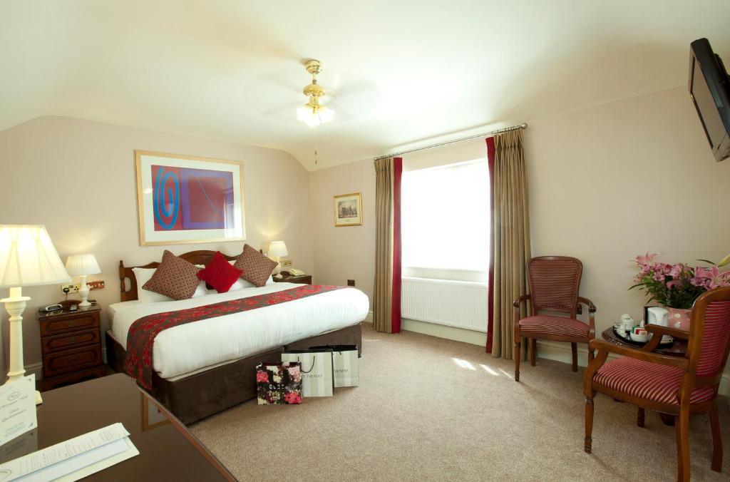 a hotel room with a bed and a desk and chair at Harrington Hall in Dublin