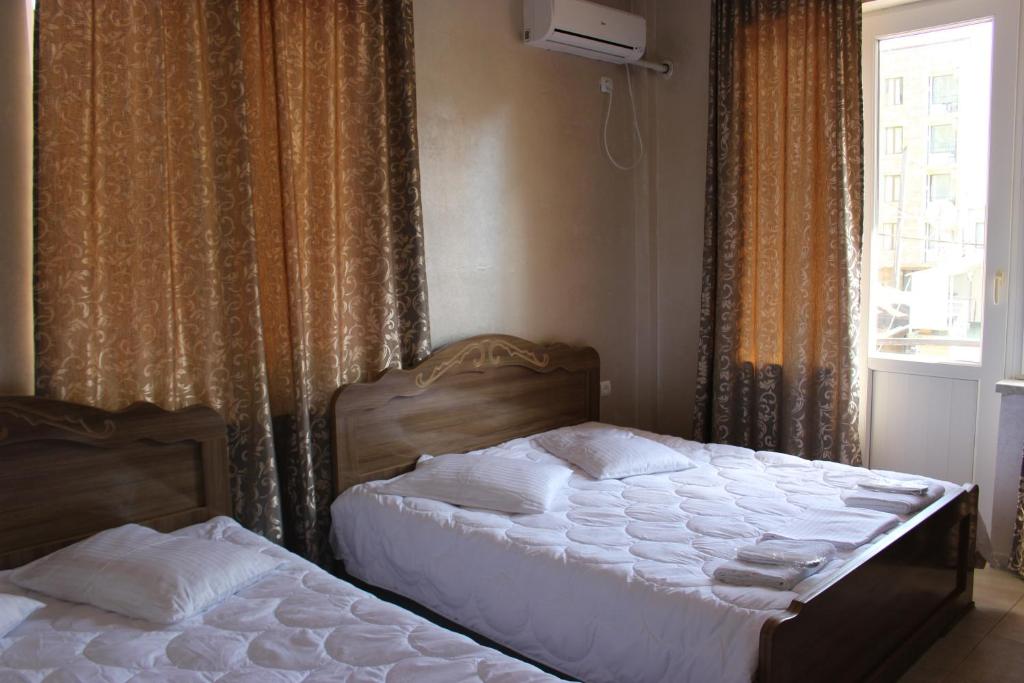 Postel nebo postele na pokoji v ubytování Hotel Evrazia