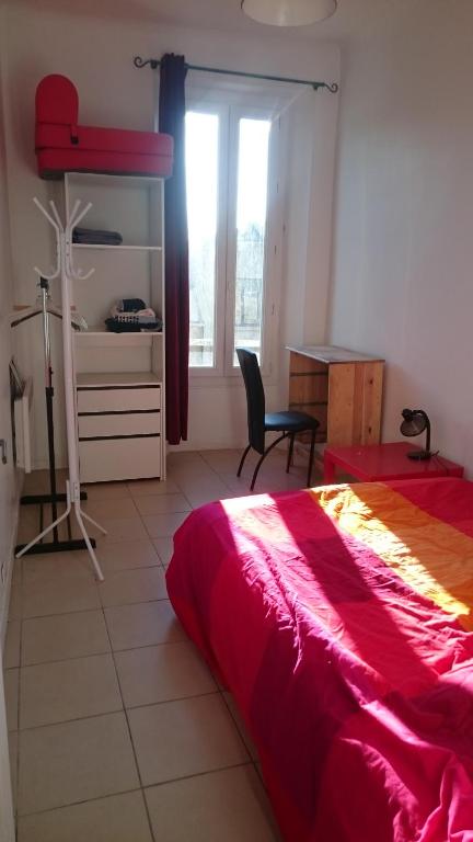 a bedroom with a bed and a desk and a window at St Charles / La Friche in Marseille