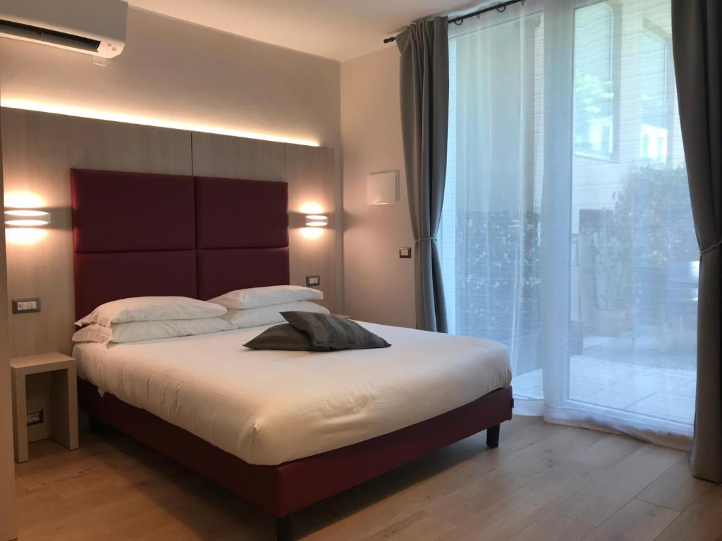 um quarto com uma cama grande e uma janela grande em Verona Apartments & Rooms em Verona