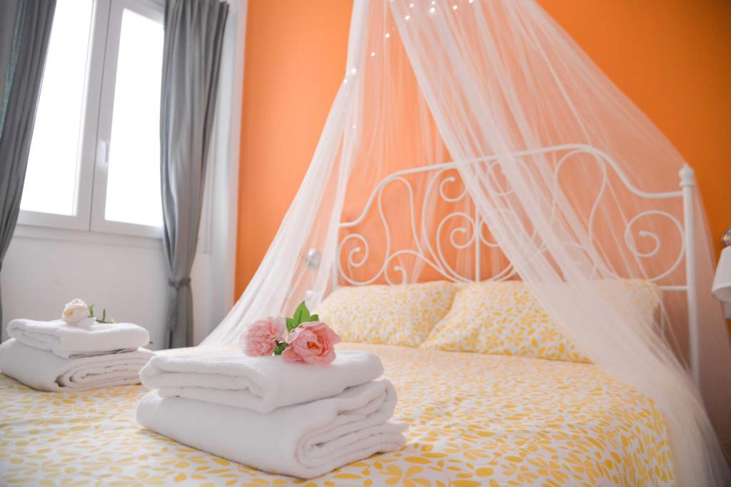 a bedroom with a bed with towels on it at Vatican Mirò Holidays in Rome