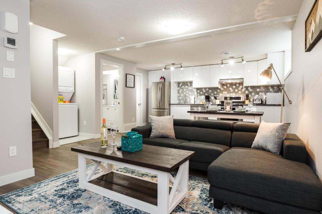 a living room with a couch and a table at Modern Executive Suite I Complimentary Netflix & Parking! in Edmonton