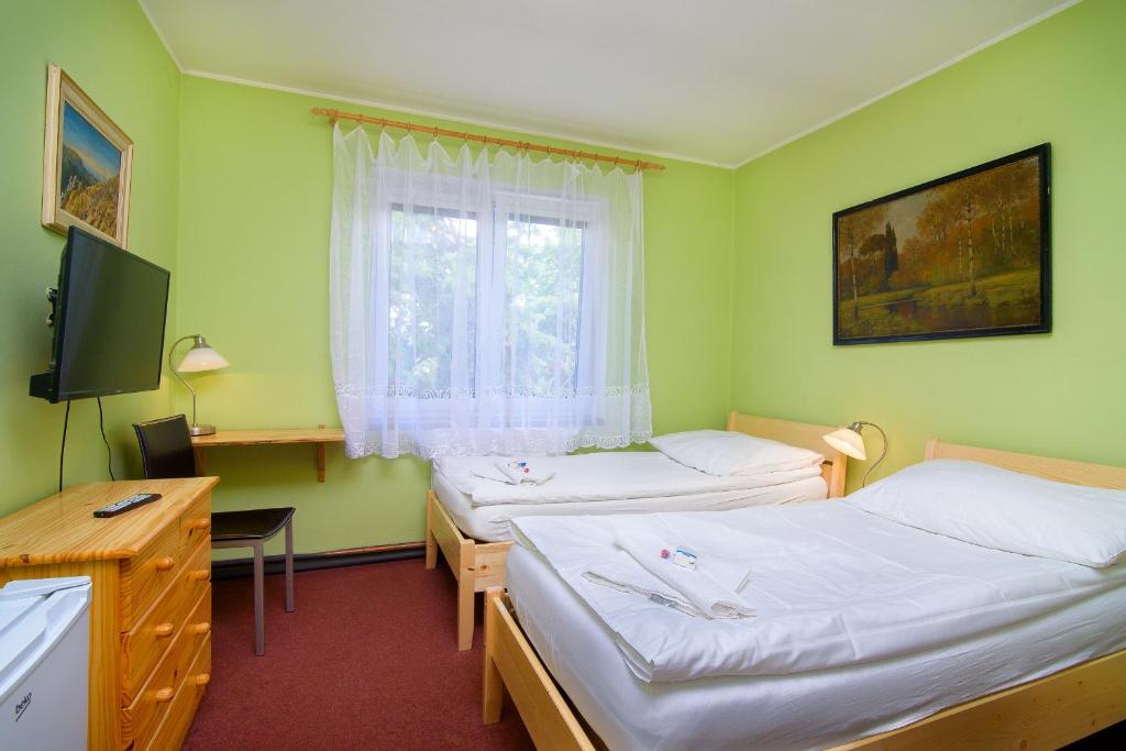 Postel nebo postele na pokoji v ubytování Hotel Max