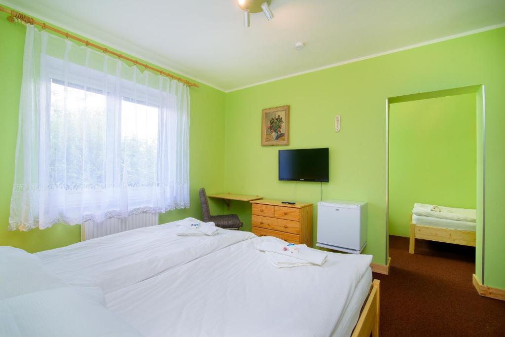 Postel nebo postele na pokoji v ubytování Hotel Max