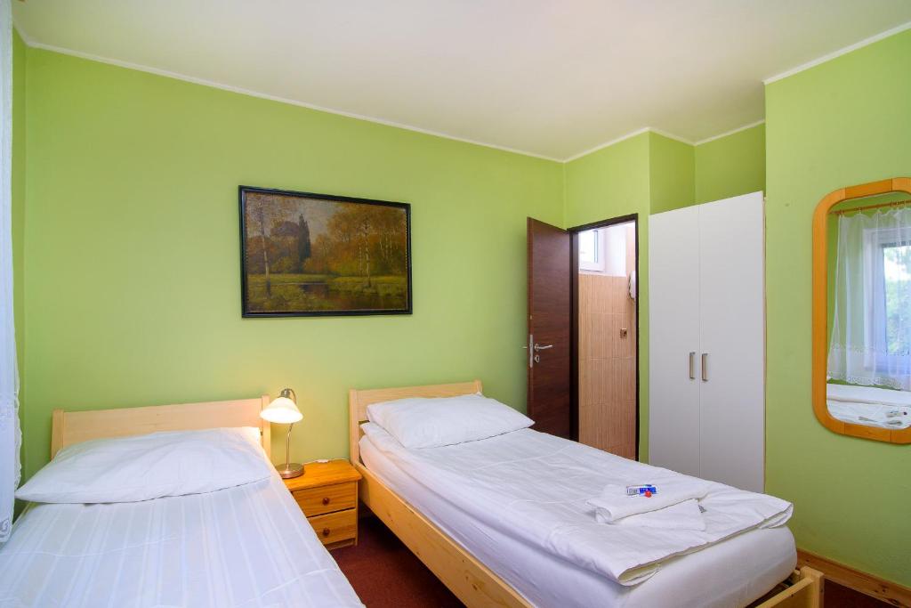 Postel nebo postele na pokoji v ubytování Hotel Max